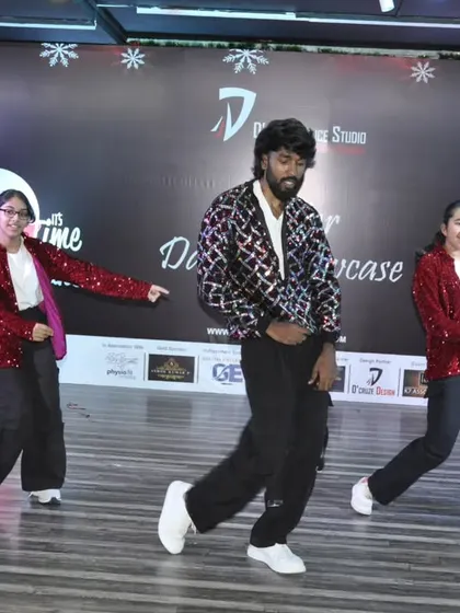 The group moves in sync during their performance, dressed in festive sequined jackets. We also help with costume ideas for performances.
