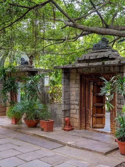 Every path here is an invitation to explore. This walkway, lined with stone pillars and lush plants, leads to another of the venue's hidden gems.