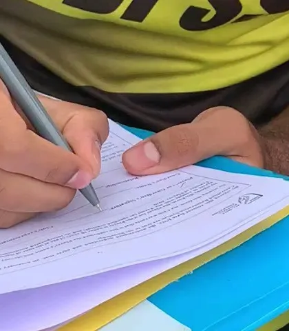 The moment of signing. This represents Akash's continued commitment to his professional football career.
