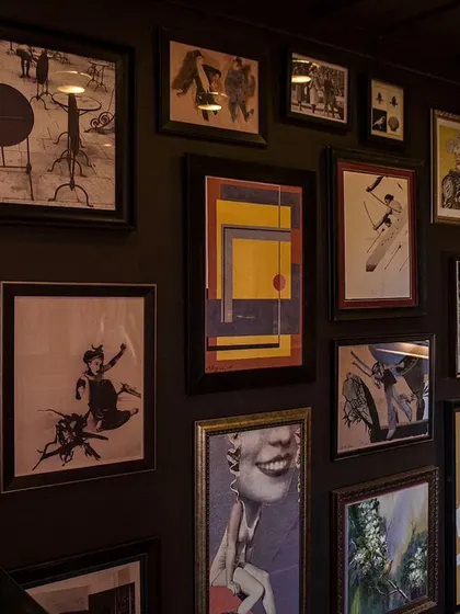 The art wall in my house is a curated collection of prints and paintings that reflect my eclectic taste.