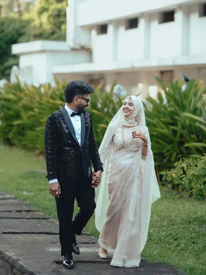 The couple enjoys a walk together, their smiles and hand-holding showing their easy and happy connection.