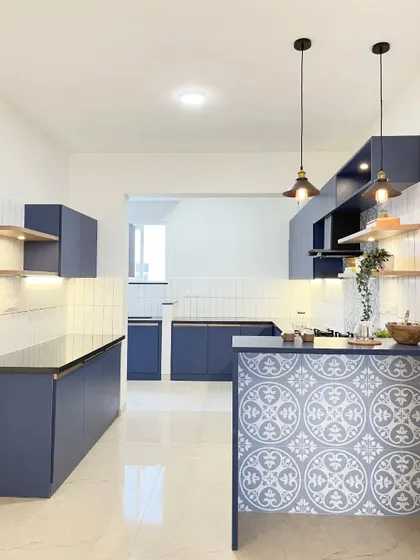 Another angle of the spacious and stylish blue kitchen, showing how the design remains open and connected to the rest of the home.