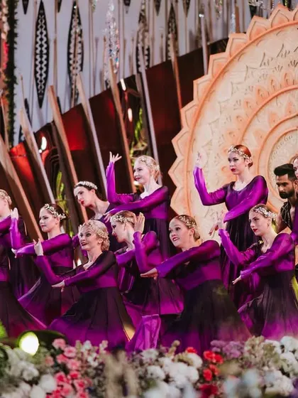 A closer look at the precision and grace of our international dancers during a sangeet performance. Dressed in elegant purple gowns, they perform a synchronized routine that adds a touch of world-class artistry and sophistication to the event.