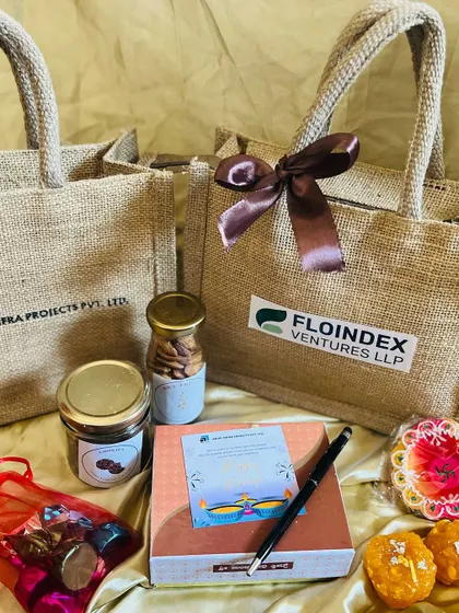 I offer logo branding on various packaging types. Here are two examples of corporate gift bags with logos for 'Ariel Infra Projects' and 'Floindex Ventures', ready for a festive giveaway.