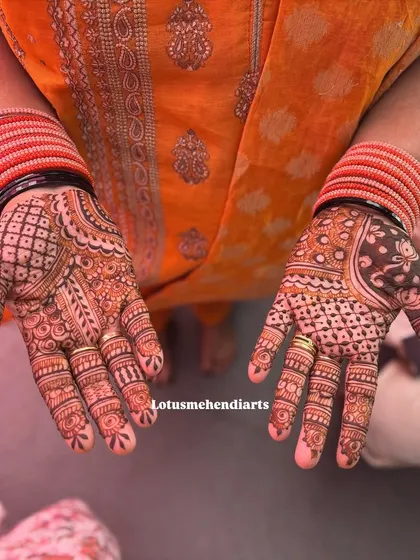A pair of full-palm designs for a guest, showcasing intricate line work and traditional motifs.