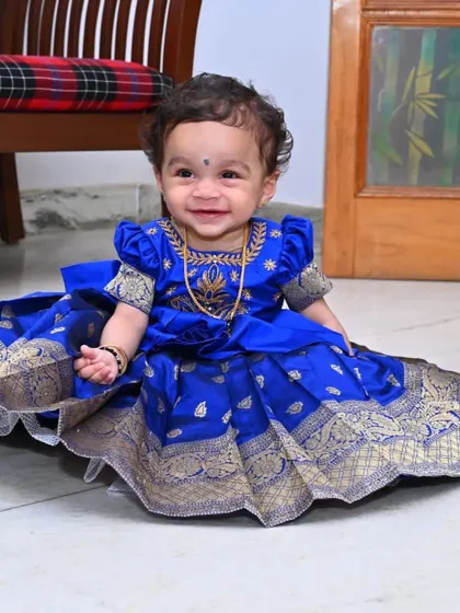 The smiling face of a happy client says it all. This royal blue Pattu Pavadai was designed to make her feel special on her big day, combining traditional elegance with a comfortable fit for a happy celebration.