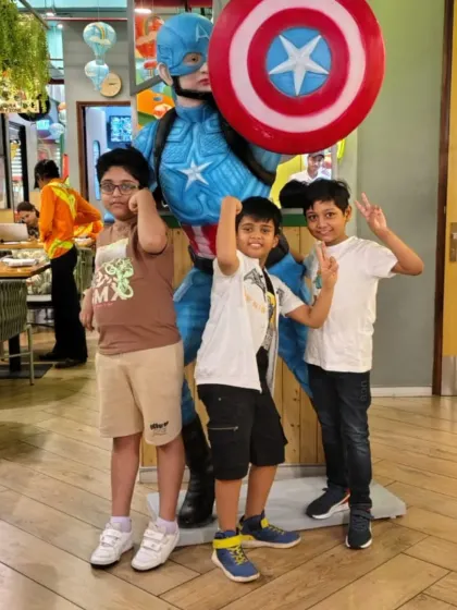 Three friends strike a superhero pose with our Captain America statue. It's a popular spot for kids to capture their fun day at Tingaland.
