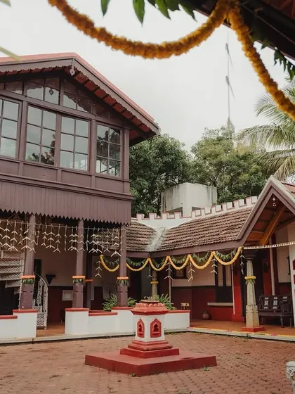 A traditional courtyard venue decorated with simple yet elegant marigold garlands for a classic and timeless wedding celebration.