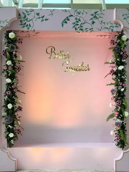 A fine-detailed, contemporary photo booth backdrop with hand-painted chinoiserie-style patterns and delicate floral arrangements.