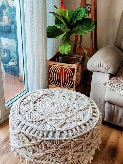 An overhead view of the macrame stool, showing the beautiful mandala-like pattern on top.