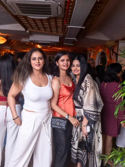 The stylish crowd that makes VIBE CHECK special. A group of friends posing for a picture, enjoying the atmosphere at Monkey Bar.