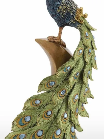 And this is the 'after'. A beautifully painted and detailed peacock sculpture, showing the final result of our clay art workshops.