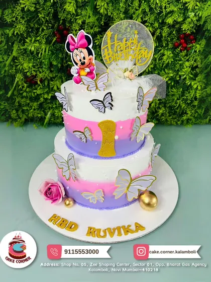 A beautiful two-tier Minnie Mouse cake with butterflies and a rose. The mix of pink and purple pastels makes it a dreamy choice for a special birthday.