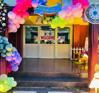 The grand entrance to the 'Oderland' party, with a colorful balloon arch and character cutouts welcoming the guests.
