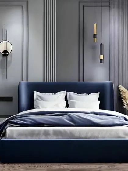 A bold and contemporary bedroom design featuring a deep blue upholstered bed against a grey paneled wall. The sleek, modern wall sconces and minimalist side tables complete this sophisticated look.