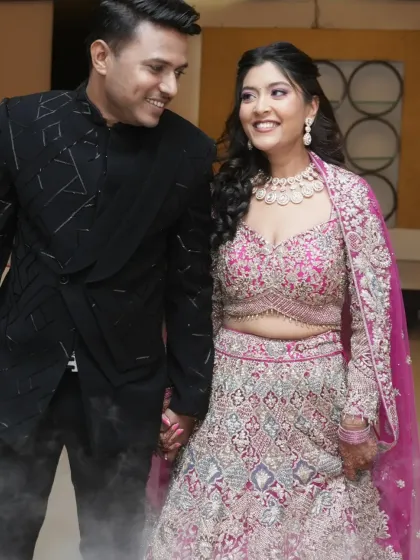 A happy couple, ready to celebrate their engagement. Her makeup is fresh and radiant, with soft curls completing the romantic look.