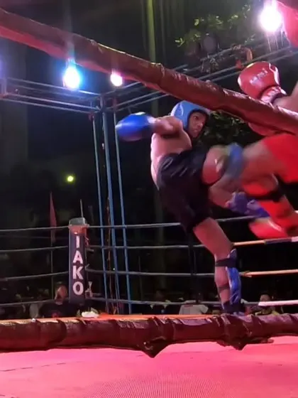 A powerful body kick from Kartik, showing his resilience and fighting spirit.
