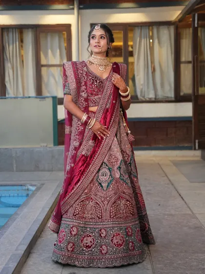 For a grand reception, a bride deserves to feel like royalty. I designed this full-glam look to match the opulence of her deep red velvet lehenga, ensuring she was the star of the evening.