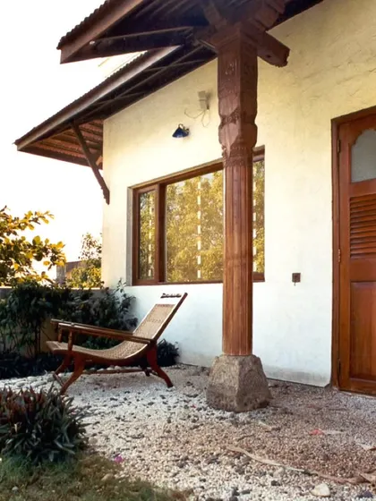 Another view of the reclaimed pillar and lounge chair, showcasing a small, private outdoor space designed for rest and reflection.