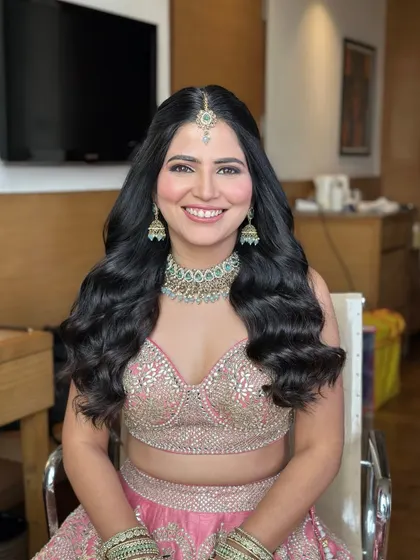 A happy engagement bride with a simple half-up style and beautiful, healthy-looking waves.