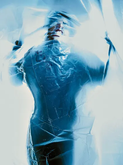 Another shot from the plastic wrap series. The way the light passes through the material creates an ethereal, almost liquid effect around the model's form.