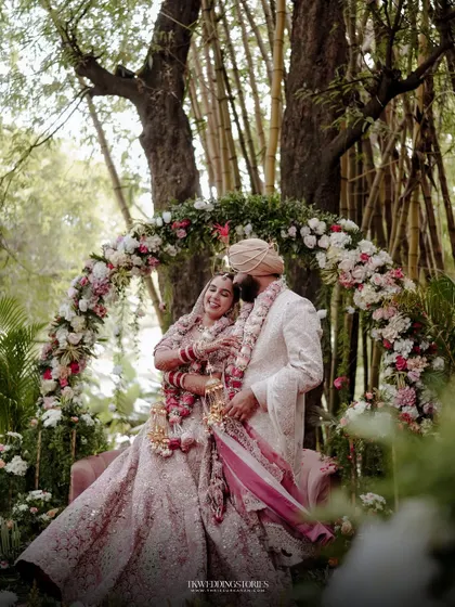 A fairytale moment for a Punjabi couple, framed by a stunning floral arch in a lush Bangalore garden. This shot showcases my approach to creating grand, yet intimate, wedding portraits.