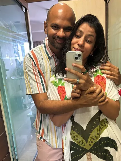 Another cute, color-coordinated moment with my husband. My fruit-print dress and his striped shirt make for a fun and playful couple look.