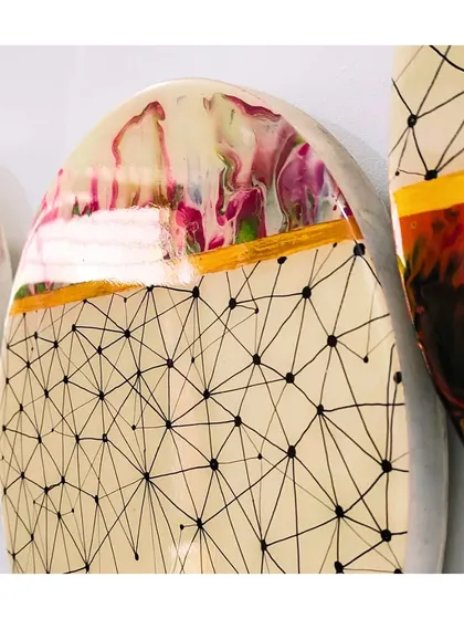 A close-up of one of the panels. The delicate, web-like doodle contrasts with the soft, blended colors of the resin pour, separated by a bold gold line.