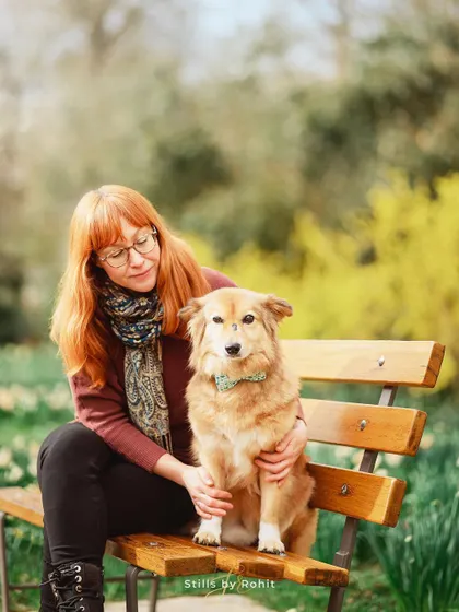 A quiet moment on a park bench with her handsome dog, Monty. The soft light and natural setting make for a beautiful, contemplative portrait.
