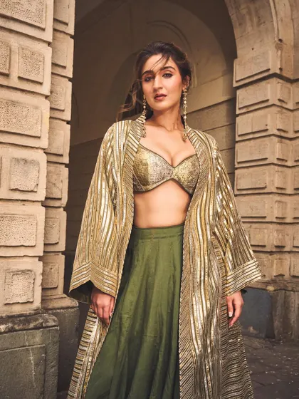 A classic pose that shows off the outfit's silhouette and the elegant drape of the jacket. It’s a look that’s both powerful and graceful.