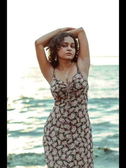 This pose creates strong, dynamic lines with the arms. It's a powerful stance that works well for fashion photography, especially with the open sea as a backdrop.