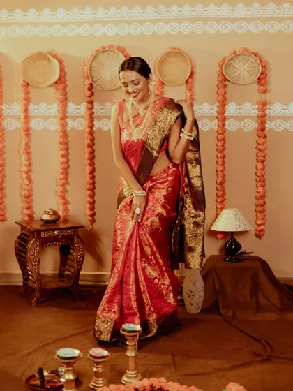 A full-length shot showing the entire Diwali setup in my studio, with marigold decorations and diyas. The model's candid smile makes the shot feel authentic and joyful.