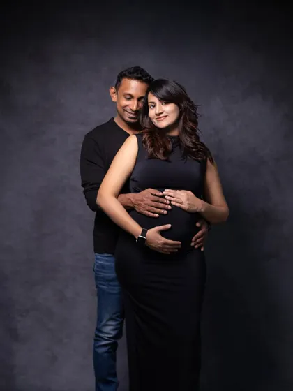 A classic, elegant couple's portrait against a dark grey backdrop, which makes the subjects stand out beautifully.