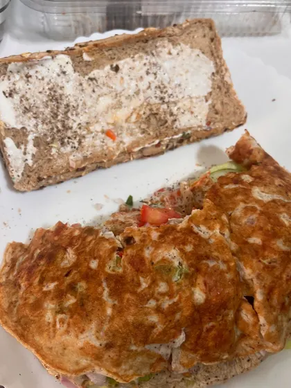 The sandwich is ready to be closed. The combination of protein from the egg and fiber from the bread and veggies makes this a perfectly balanced meal.