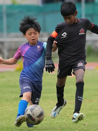 A fierce battle for the ball during our Ooty tour friendly match. Our players are taught to be strong and fair in every challenge.