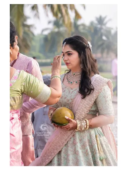 A candid moment from Reshma's engagement ceremony. Her makeup looks flawless and natural, perfect for the daytime outdoor event.