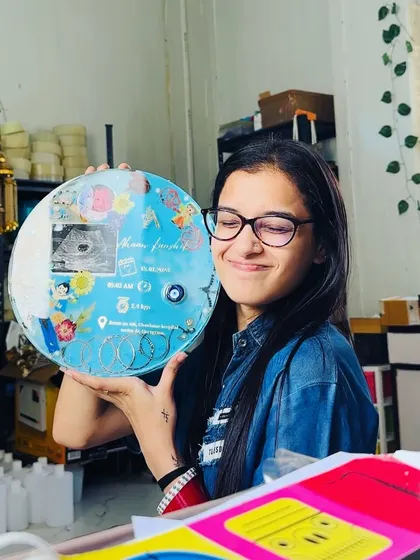Another shot with this special baby keepsake. The combination of personal items like the ultrasound and kadas with artistic elements like flowers and colors makes each piece truly unique.