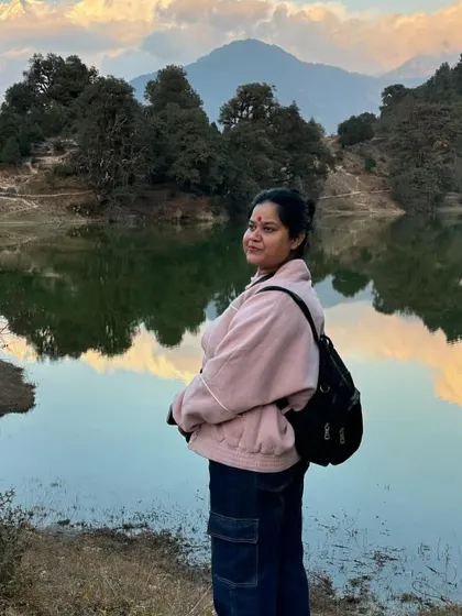 A traveler soaking in the serene beauty of Deoriatal lake, a perfect spot for reflection and peace.