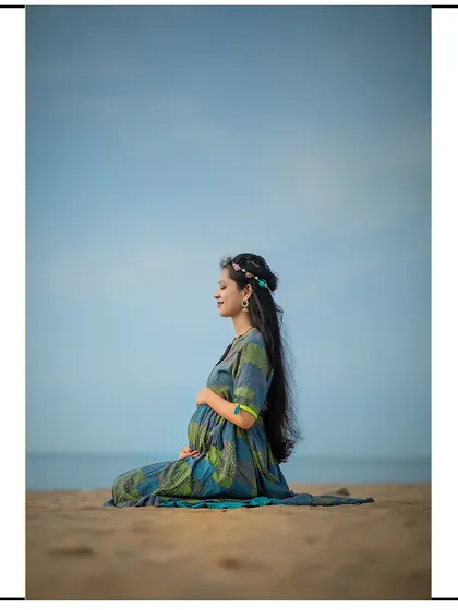 A peaceful moment of meditation on the beach, connecting with the baby and the sound of the waves.