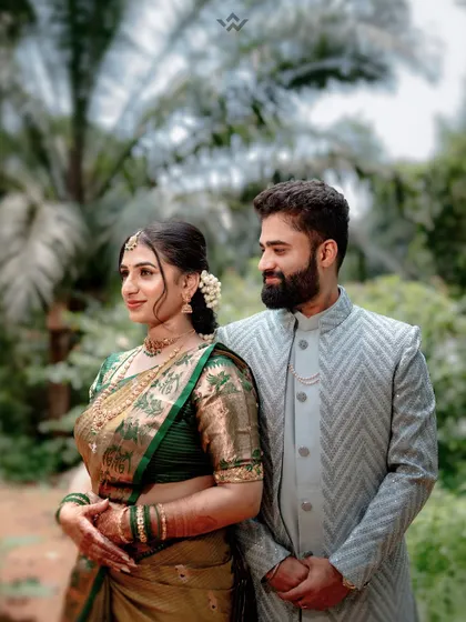 A beautiful portrait of a couple in their engagement attire, set against the lush greenery and traditional architecture of Sringeri.