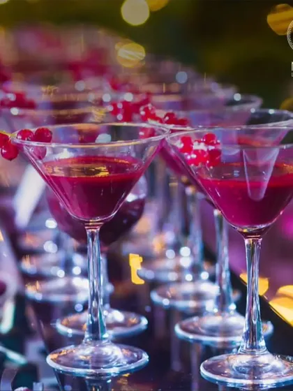 A refreshing start to any party. These vibrant red cocktails, garnished with fresh berries, are both visually appealing and delicious.