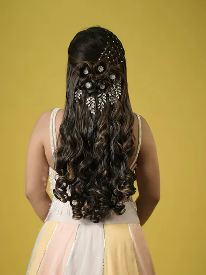 A full view of the glamorous half-updo, showcasing the artistry and creativity that goes into creating such a detailed hairstyle.