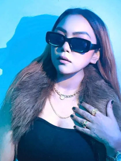 A stylish shot with sunglasses, bathed in cool blue light.