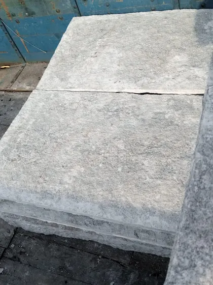 Narasapura stone slabs loaded on a truck, showing their thickness and rough-hewn edges.