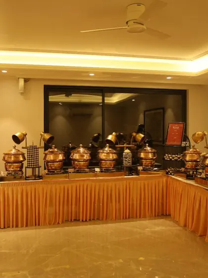 Another angle of the extensive buffet setup for a housewarming party, showcasing the scale and professionalism I bring to indoor events. The warm lighting highlights the beautiful copper pots.