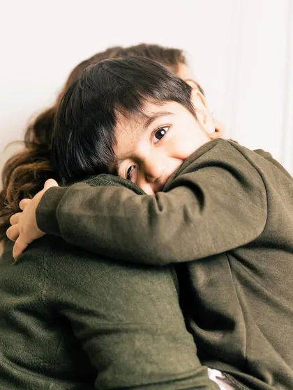A son’s first love and a mother’s forever valentine. This sweet hug, with his little eyes peeking over her shoulder, is a moment of quiet connection that speaks volumes.