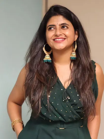 A candid shot, looking away with a smile.