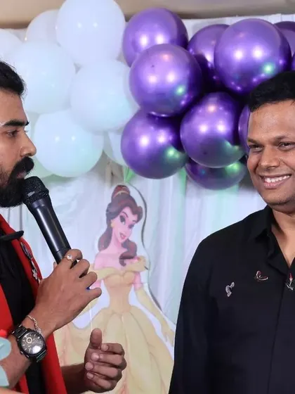 Interacting with a guest on stage, creating a fun and personal experience.