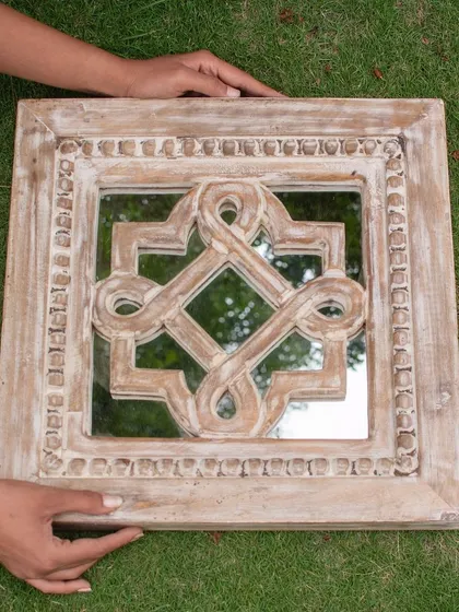 Holding this mirror gives you a true sense of its quality and craftsmanship. You can feel the substantial weight of the mango wood and see the unique imperfections that make each hand-carved piece a one-of-a-kind treasure for your home.