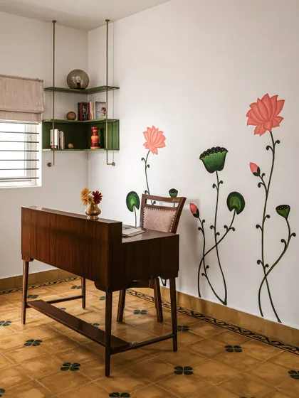 An open study area on the first floor of 'Project Varnika', featuring hand-painted Pichwai murals that deepen the home's cultural resonance.